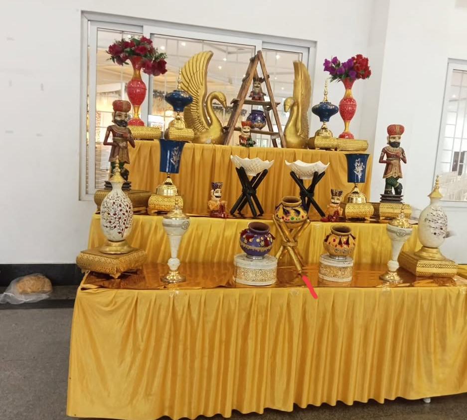 Tiered golden stall with marble and brass decor